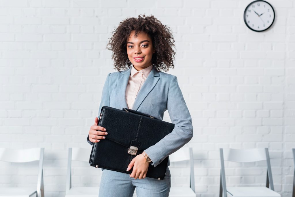 African american businesswoman in suit holding briefcase