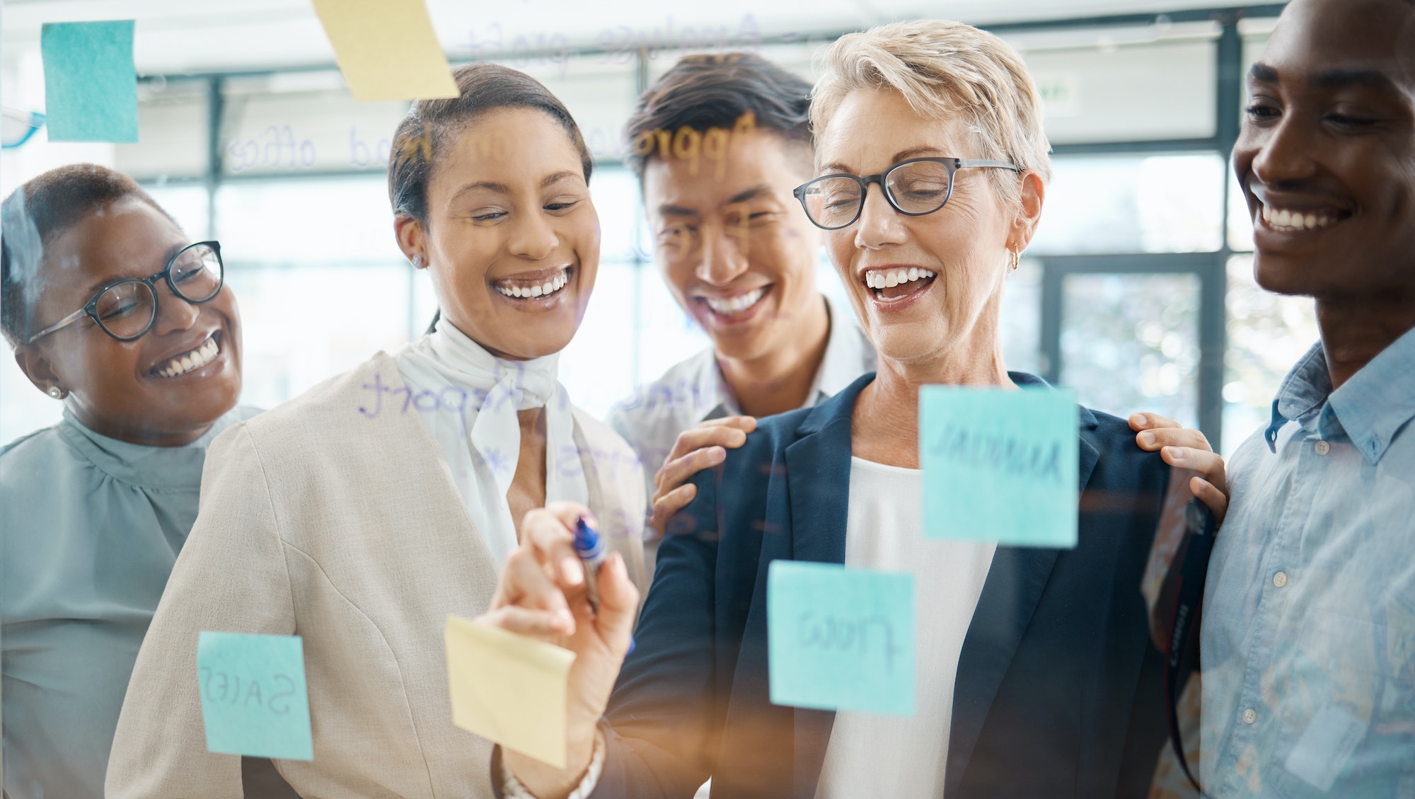 Teamwork, planning and strategy with a business woman, manager or CEO working with a team on a glas